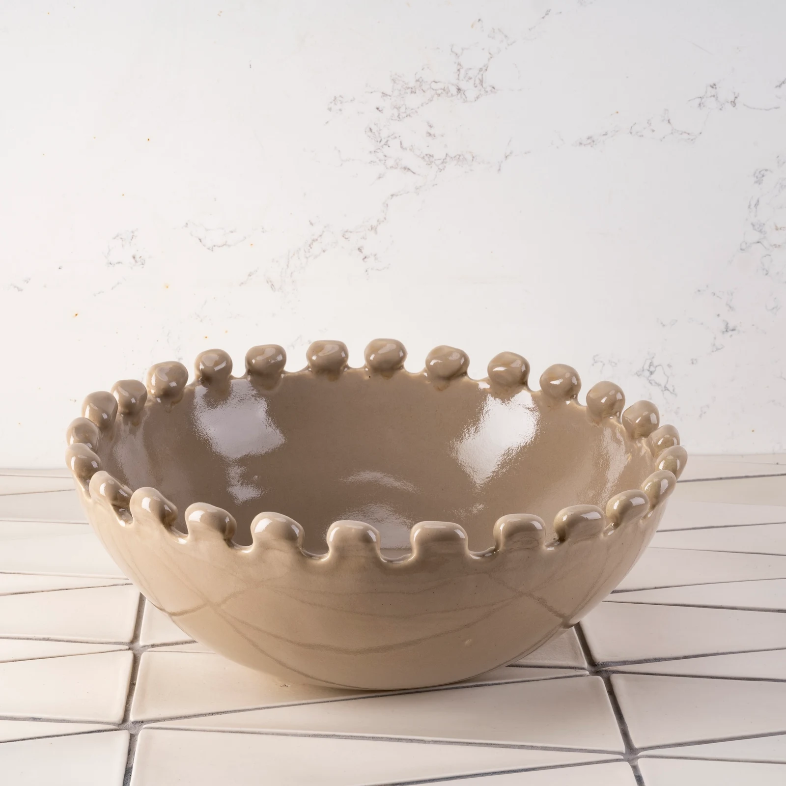 Large Malibu salad bowl in glossy sand with a rounded bobble rim, front view
