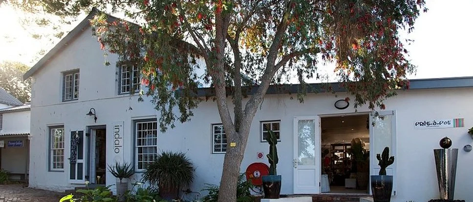 The white Pret-a-pot storefront at Old Nick Village in Plettenberg Bay