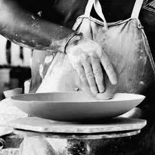 Hands shaping a ceramic bowl, the craft at the heart of our Gqeberha factory